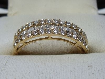 a close up of a diamond ring on a white cloth