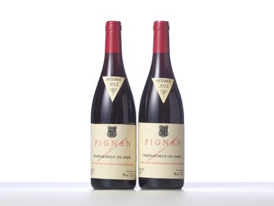 two bottles of red wine sitting next to each other on a table