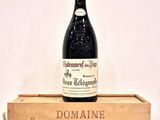 a bottle of wine sitting on top of a wooden box