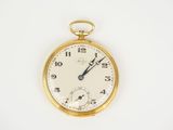 a close up of a pocket watch on a white surface