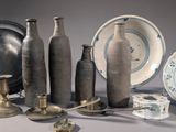 many different types of vases and plates on the table