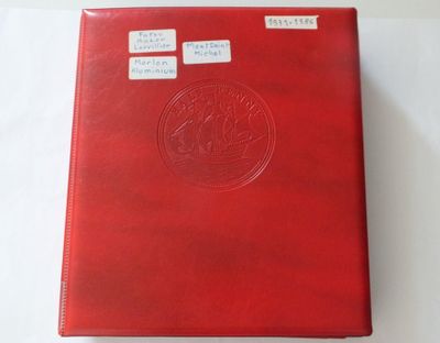 a red folder with stickers on it sitting on a table