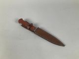 a small knife that is laying on a white surface