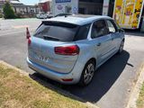 a silver car that is parked on the side of the road