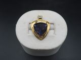 a close up of a ring with a blue stone in it