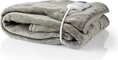 a blanket that has a remote control on top of it