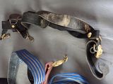 two belts and a pair of scissors on a table
