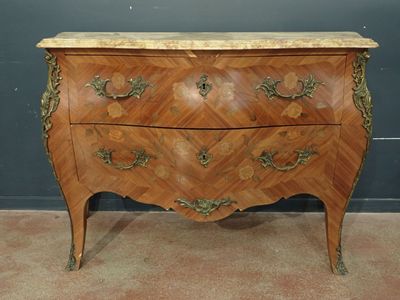 a wooden chest of drawers with a marble top