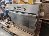a silver oven sitting on a pallet in a warehouse