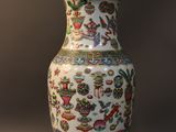 a vase on a stand with a lamp on top of it