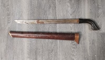 a knife that is laying on the floor next to a knife