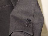 a close up of a man wearing a suit and tie
