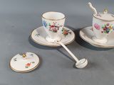 three cups and saucers are sitting on a gray surface