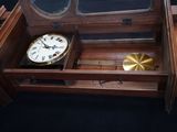 a clock in a wooden box with a mirror on top