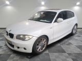 a picture of a white bmw car in a garage