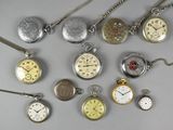 many different types of pocket watches on the table