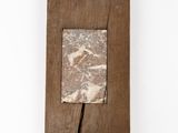 an image of a piece of wood with a marble in it