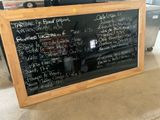 a blackboard with writing on it sitting on the floor