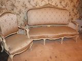 a couch and two chairs in a room with a wallpapered wall