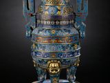 an image of a blue and gold vase with a lion on it