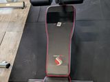 a gym room with a bench, dumbs, and other equipment