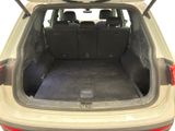 the back end of a car with the trunk open and the seats down