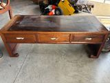 une table basse avec trois tiroirs, dans un garage