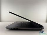 the back of a laptop computer sitting on top of a white table