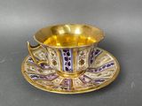 purple and gold tea cup and saucer