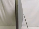 a computer monitor sitting on a stand on a white surface