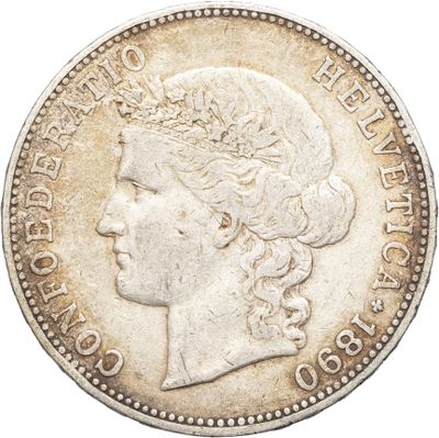 gros plan d'une pièce de monnaie sur laquelle figure une tête de femme