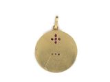 a close up of a gold coin with a cross on it