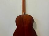 a guitar hanging on a wall in a room