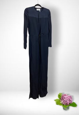 navy blue jumpsuit with long sleeves and a tie belt