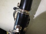 a close up of a clarinet with a black body and silver body