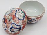 a small bowl with a lid sitting on a table