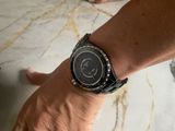 a man that is holding a watch on his wrist