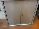 a metal cabinet with a glass top in a room