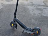 a scooter that is sitting in the middle of a parking lot