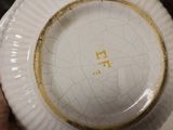a person holding a plate with a gold design on it