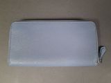 a blue leather wallet sitting on top of a table