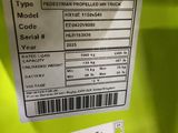 a close up of a label on the back of a green vehicle