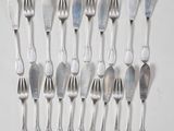 a lot of silver spoons and forks on the table
