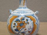 a small vase with a floral design on it