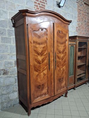 a wooden cabinet with a glass door in a room
