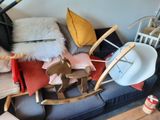 a couch with a rocking horse and a hat on top of it