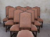 six chairs with upholstered backs and upholstered backs are lined up against a wall