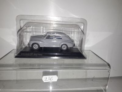 a silver car in a clear box on a table