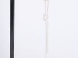 silver plated chain earrings with dangling beads on a black stand
