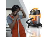 a woman standing next to a vacuum and a vacuum cleaner